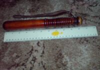 Short CID-style British police truncheon with ruler for scale