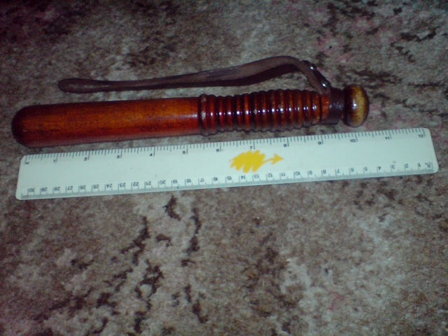Short CID-style British police truncheon with ruler for scale